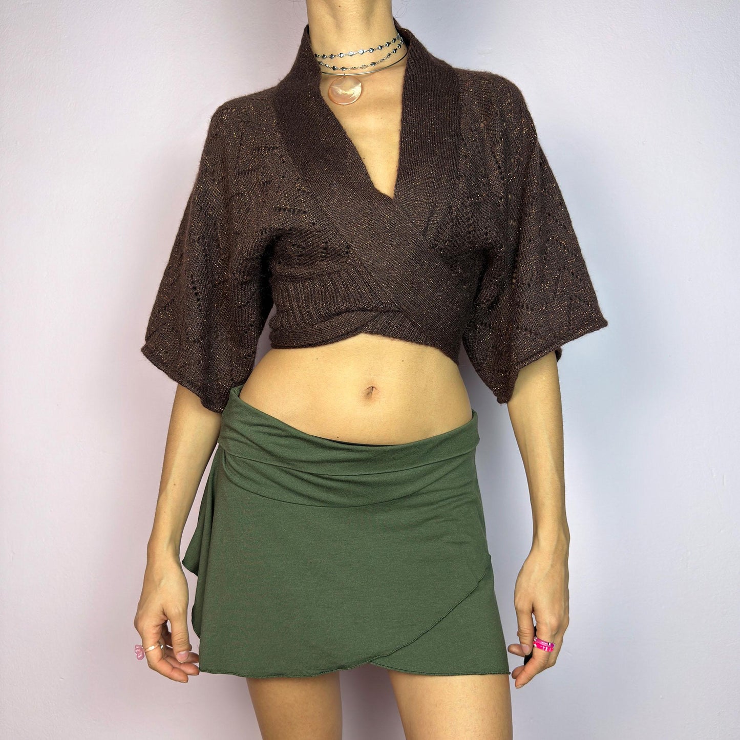 The Y2K Brown Knit Cardigan Bolero is a chic vintage 2000s piece. This cropped bolero features an open-knit design, short sleeves, and a long tie-front closure for an adjustable fit. Its warm brown tone. adult world shop