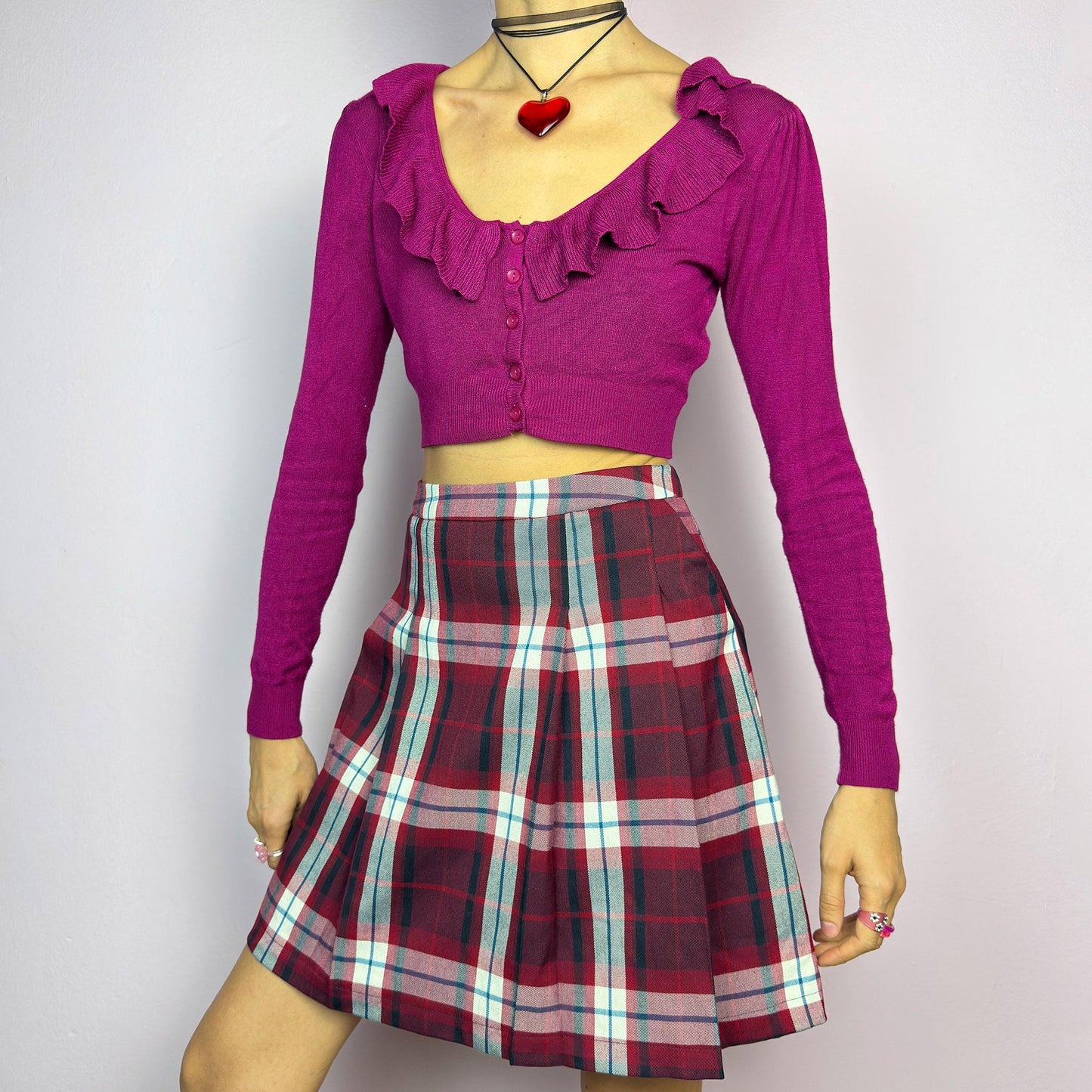 The Y2K Red Plaid Pleated Mini Skirt is a vintage 2000s essential featuring a structured pleated design in a bold red, navy, and white plaid pattern. Made from a woven fabric, it’s perfect for preppy, punk, or casual outfits. adult world shop