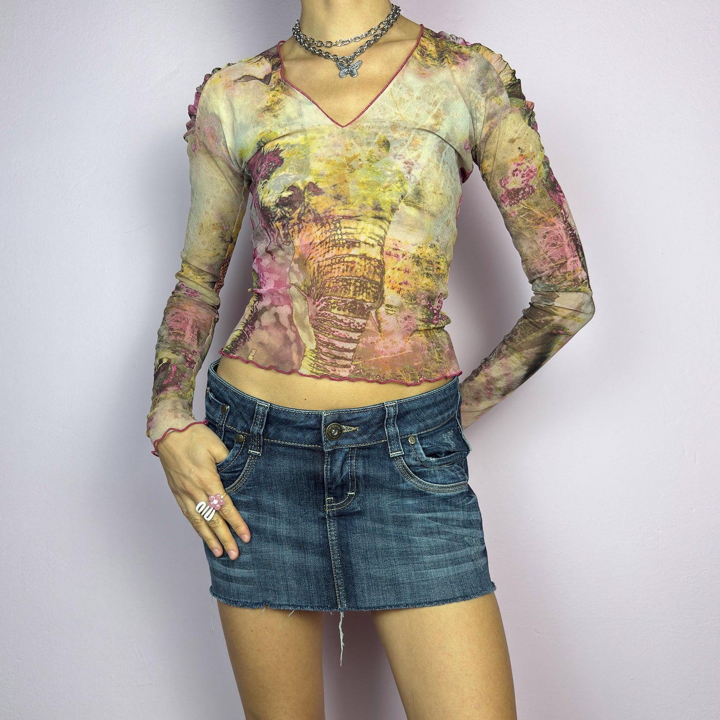 The Y2K Low Rise Mini Dark Denim Skirt s a 2000s essential, featuring a short micro length with a low-rise waist, a zipper and button closure, and crafted from a dark-wash stretch denim. Designed with raw hem, and a five-pocket. adult world shop