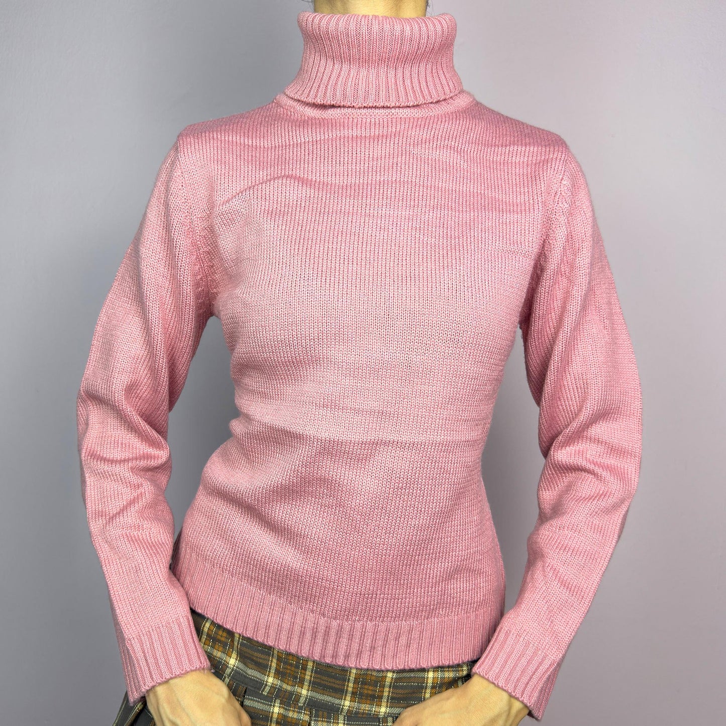 This Y2K Pink Turtleneck Sweater is a cozy 2000s essential with a minimalist vintage aesthetic. Crafted from a soft, knit fabric in a muted pastel pink, it features a classic high turtleneck, a fitted silhouette for a flattering look and long sleeves with ribbed cuffs. Ideal for casual or preppy winter styles. adult world shop