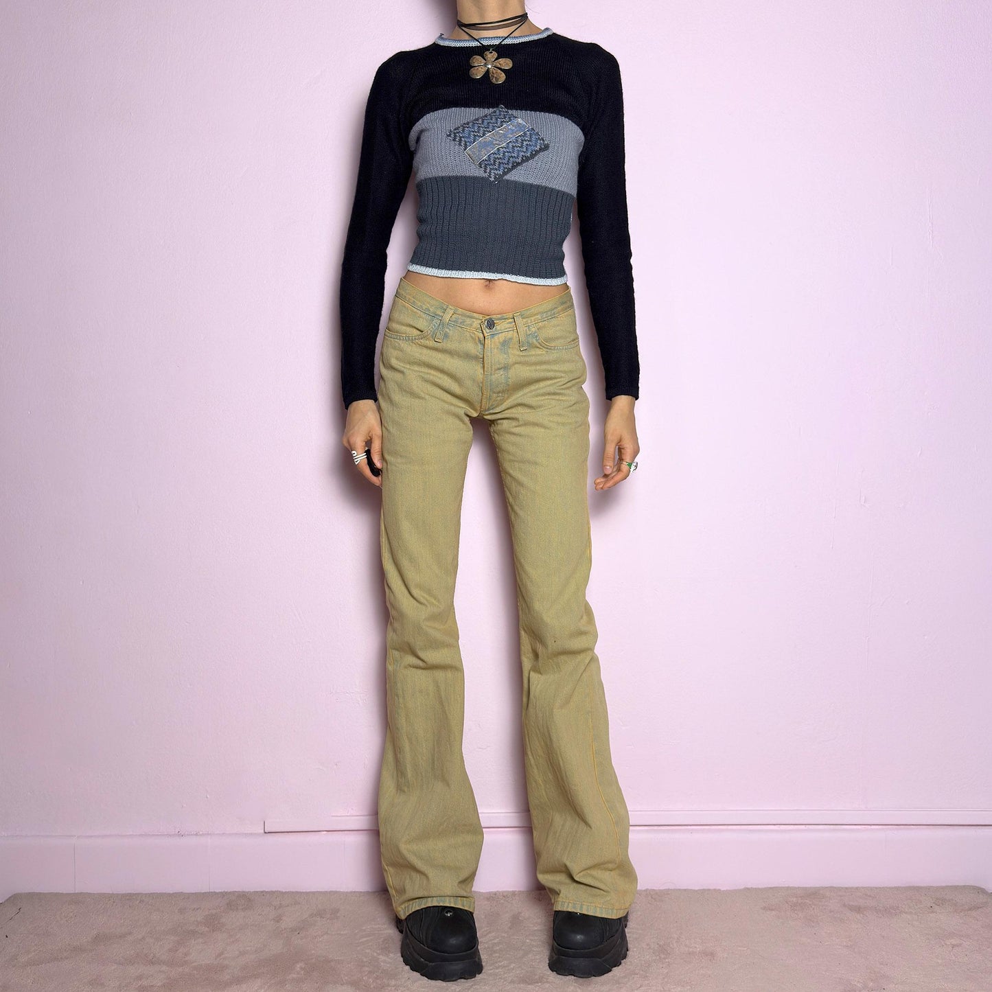 The Y2K Low-Rise Flare Jeans are a vintage 2000s staple featuring a structured denim fabric in a muted earthy tone with a slightly washed effect. Designed with a flattering low-rise fit, button closure, pockets and a flared leg that creates a sleek silhouette, these jeans are perfect for casual outfits. adult world shop