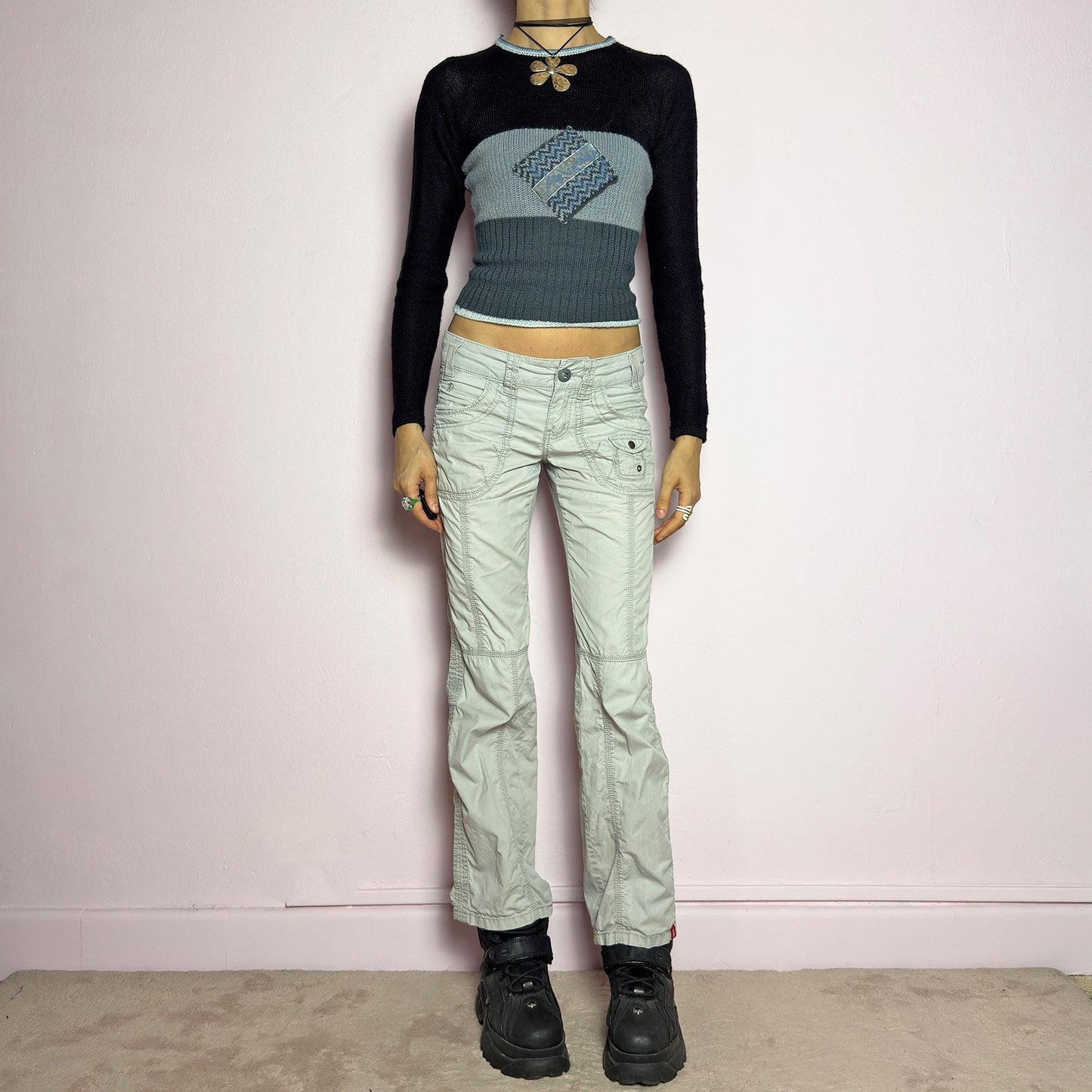 The Y2K Gray Low-Rise Pants are a vintage 2000s piece featuring a lightweight, structured fabric with a washed gray tone. Designed with a low-rise waist, button and zipper closure, and pockets, these pants offer a cropped, relaxed straight-leg fit with contrast stitching and panel detailing for a utilitarian-inspired aesthetic. Perfect for streetwear and casual grunge looks. adult world shop