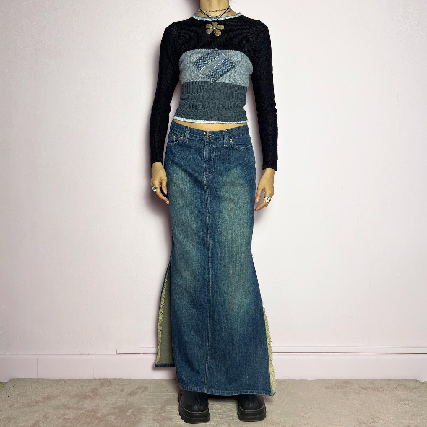 The Y2K Denim Side Slit Maxi Skirt is a vintage 2000s statement piece featuring a structured mid-rise fit and a sleek, elongated silhouette. Designed with frayed side slit details, a button and zipper closure, and classic five-pocket styling, this skirt is perfect for casual streetwear looks. adult world shop