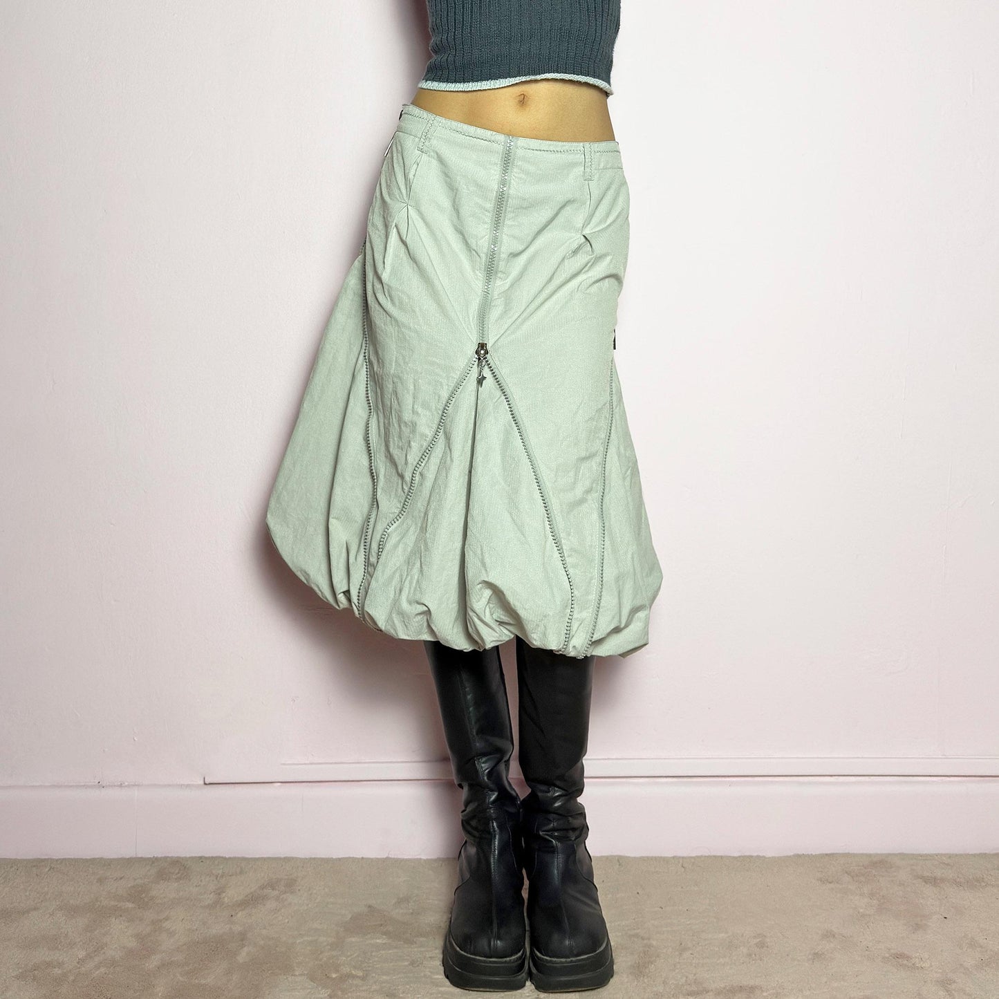 The Y2K Gray Bubble Midi Skirt is a futuristic statement 2000s piece featuring a voluminous bubble silhouette with multiple zipper details that create a dynamic, adjustable shape. Designed with a structured high-rise fit, and a side zipper closure, this skirt is perfect for bold streetwear outfits. adult world shop