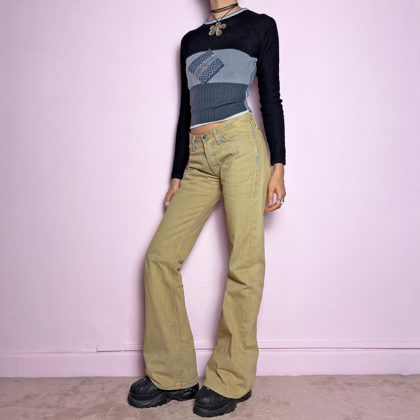The Y2K Low-Rise Flare Jeans are a vintage 2000s staple featuring a structured denim fabric in a muted earthy tone with a slightly washed effect. Designed with a flattering low-rise fit, button closure, pockets and a flared leg that creates a sleek silhouette, these jeans are perfect for casual outfits. adult world shop