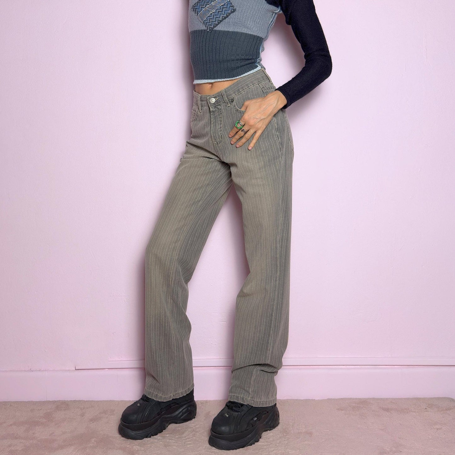 The Y2K Gray Straight Jeans are a vintage 2000s essential featuring a structured fabric with subtle pinstripes. Designed with a relaxed straight-leg fit, a flattering high waist, button and zipper closure, and pockets, these jeans offer a sleek yet effortless silhouette. Perfect for casual outfits. adult world shop