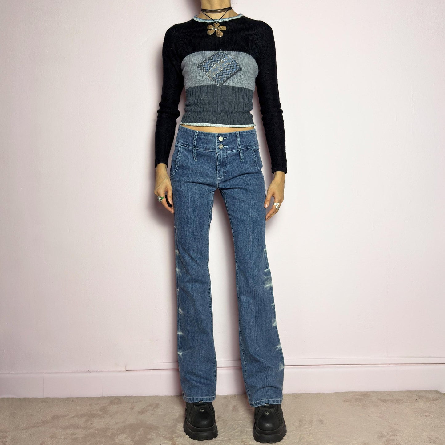 The Y2K Straight-Flare Jeans are a vintage 2000s piece featuring a stretchy denim fabric with a unique painted or bleached streak effect. Designed with a flattering low-rise fit, a slightly flared straight leg, button and zipper closure, and pockets, these jeans offer a sleek silhouette perfect for casual outfits. adult world shop