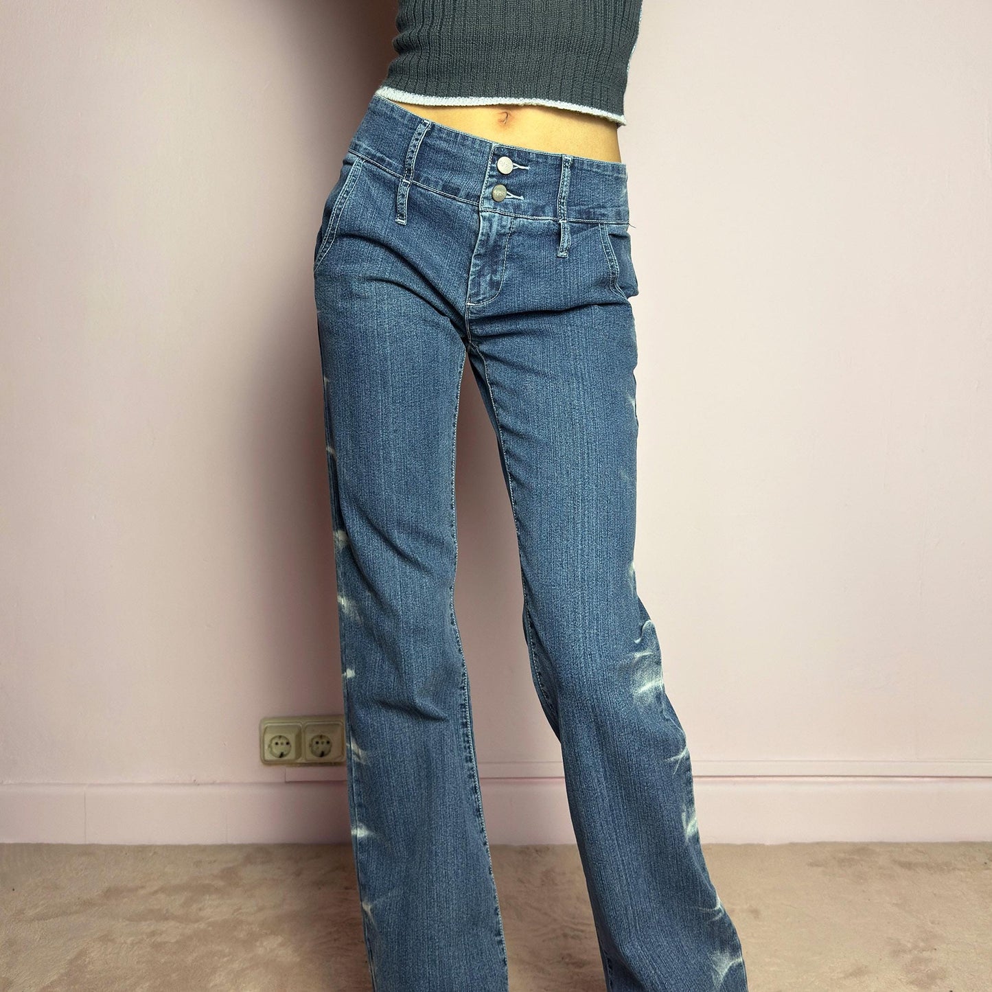 The Y2K Straight-Flare Jeans are a vintage 2000s piece featuring a stretchy denim fabric with a unique painted or bleached streak effect. Designed with a flattering low-rise fit, a slightly flared straight leg, button and zipper closure, and pockets, these jeans offer a sleek silhouette perfect for casual outfits. adult world shop