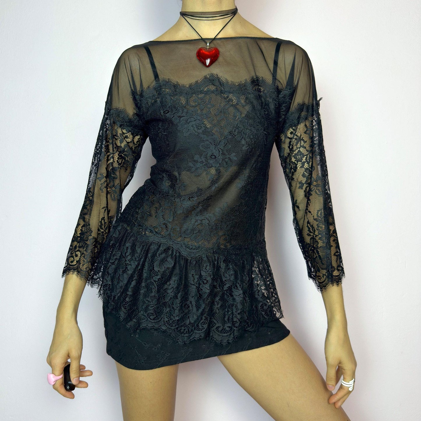 The Y2K Black Lace Peplum Top is a vintage 2000s piece featuring sheer mesh panels, floral lace detailing, and a flattering peplum hem. Designed with three-quarter length sleeves and a boat neckline for an elegant yet sultry silhouette. Perfect for layering or styling for a night out. Stretchy and lightweight for a comfortable fit. Excellent vintage condition. adult world shop