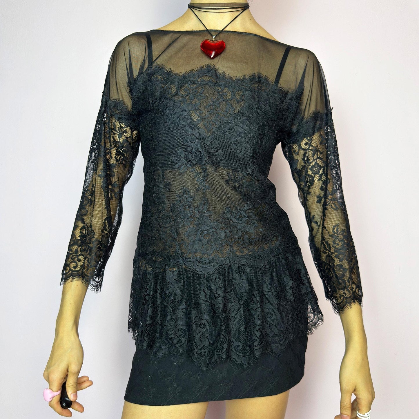 The Y2K Black Lace Peplum Top is a vintage 2000s piece featuring sheer mesh panels, floral lace detailing, and a flattering peplum hem. Designed with three-quarter length sleeves and a boat neckline for an elegant yet sultry silhouette. Perfect for layering or styling for a night out. Stretchy and lightweight for a comfortable fit. Excellent vintage condition. adult world shop