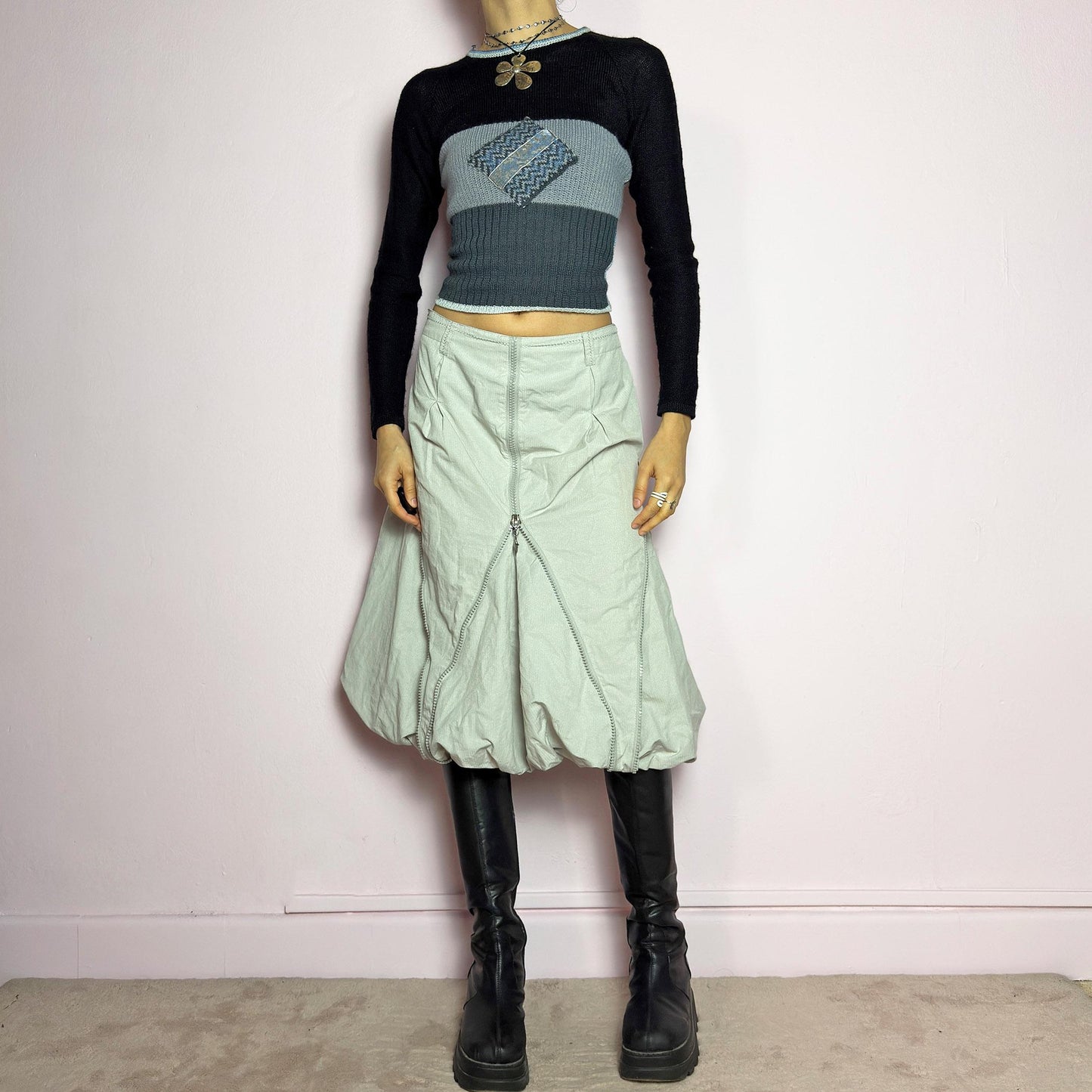 The Y2K Gray Bubble Midi Skirt is a futuristic statement 2000s piece featuring a voluminous bubble silhouette with multiple zipper details that create a dynamic, adjustable shape. Designed with a structured high-rise fit, and a side zipper closure, this skirt is perfect for bold streetwear outfits. adult world shop