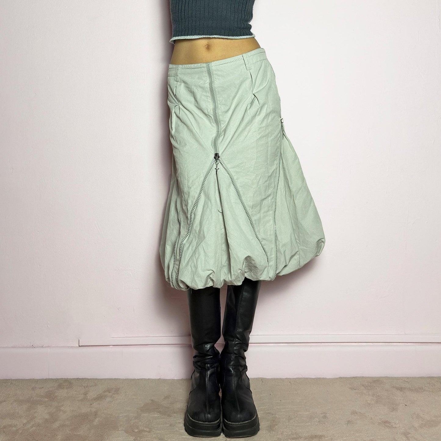 The Y2K Gray Bubble Midi Skirt is a futuristic statement 2000s piece featuring a voluminous bubble silhouette with multiple zipper details that create a dynamic, adjustable shape. Designed with a structured high-rise fit, and a side zipper closure, this skirt is perfect for bold streetwear outfits. adult world shop
