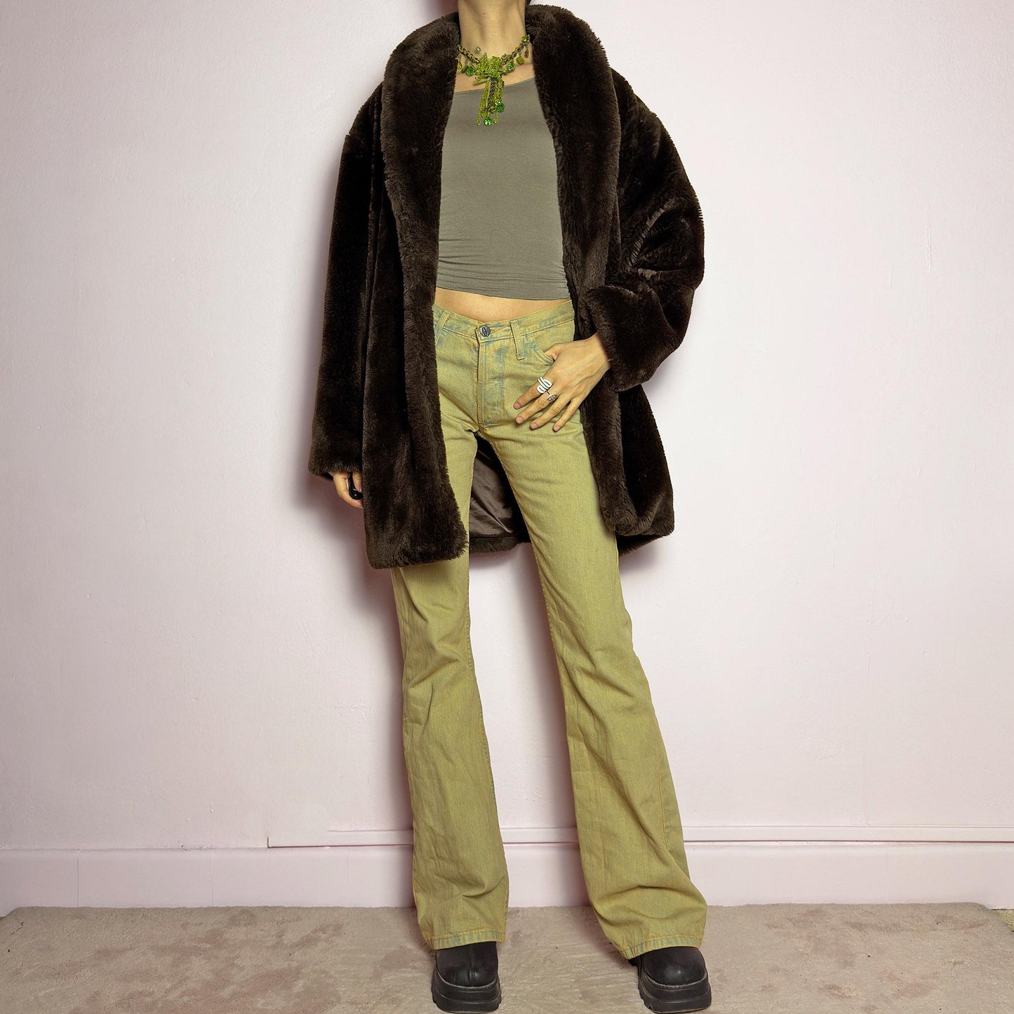 The Vintage 90s Brown Faux Fur Coat is a luxurious and cozy statement piece. Featuring a soft plush texture, and a deep chocolate brown hue, this coat exudes effortless elegance and warmth. Designed with a relaxed fit, pockets, and a hidden hook closure, it's perfect for layering over casual or dressed-up winter outfits. Made in Spain. adult world shop