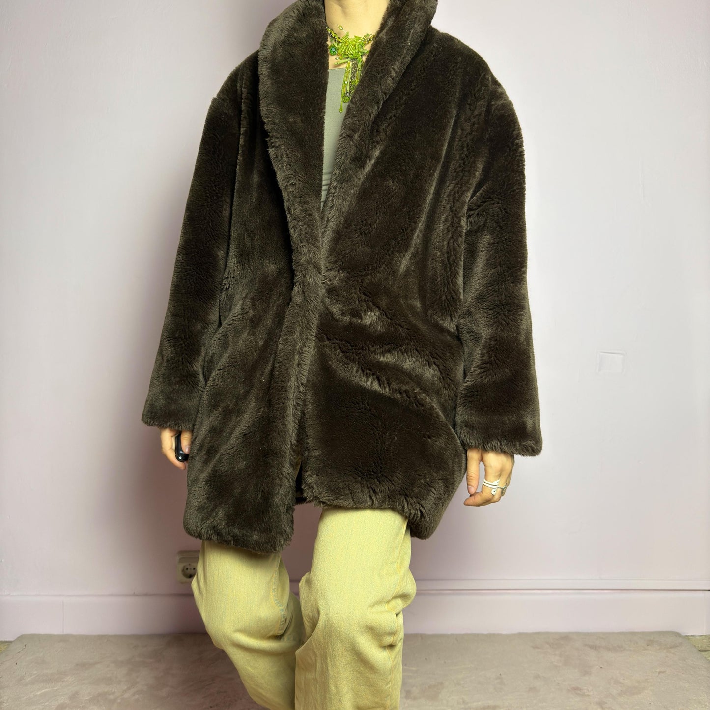 The Vintage 90s Brown Faux Fur Coat is a luxurious and cozy statement piece. Featuring a soft plush texture, and a deep chocolate brown hue, this coat exudes effortless elegance and warmth. Designed with a relaxed fit, pockets, and a hidden hook closure, it's perfect for layering over casual or dressed-up winter outfits. Made in Spain. adult world shop