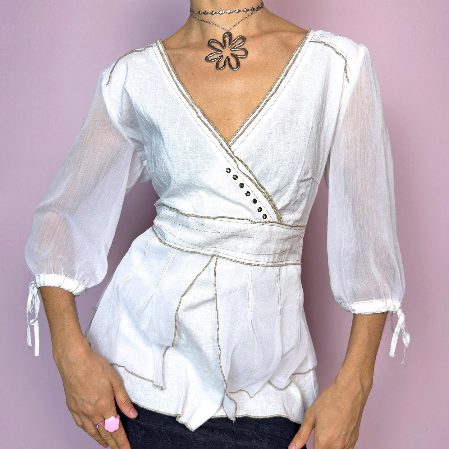 The Vintage 90s White Wrap Blouse is a dreamy romantic top featuring a soft wrap-style silhouette with subtle stitched pleats, a lightweight semi-sheer overlay with a flowy drape, three-quarter puff sleeves with delicate tie cuffs, a side zipper closure, and contrasting seam lines. This romantic piece is perfect for fairycore, cottagecore, bridal vibes, or boho summer looks. Great vintage condition.
