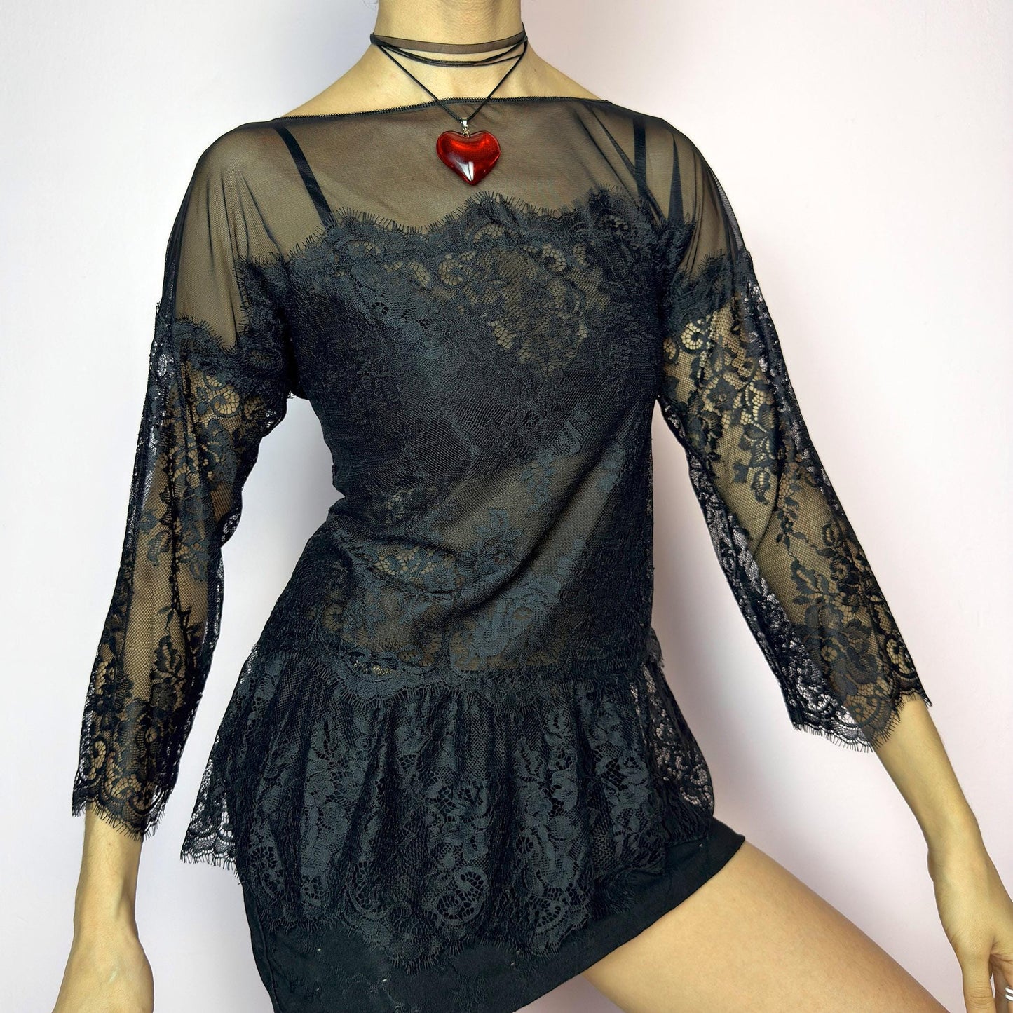 The Y2K Black Lace Peplum Top is a vintage 2000s piece featuring sheer mesh panels, floral lace detailing, and a flattering peplum hem. Designed with three-quarter length sleeves and a boat neckline for an elegant yet sultry silhouette. Perfect for layering or styling for a night out. Stretchy and lightweight for a comfortable fit. Excellent vintage condition. adult world shop