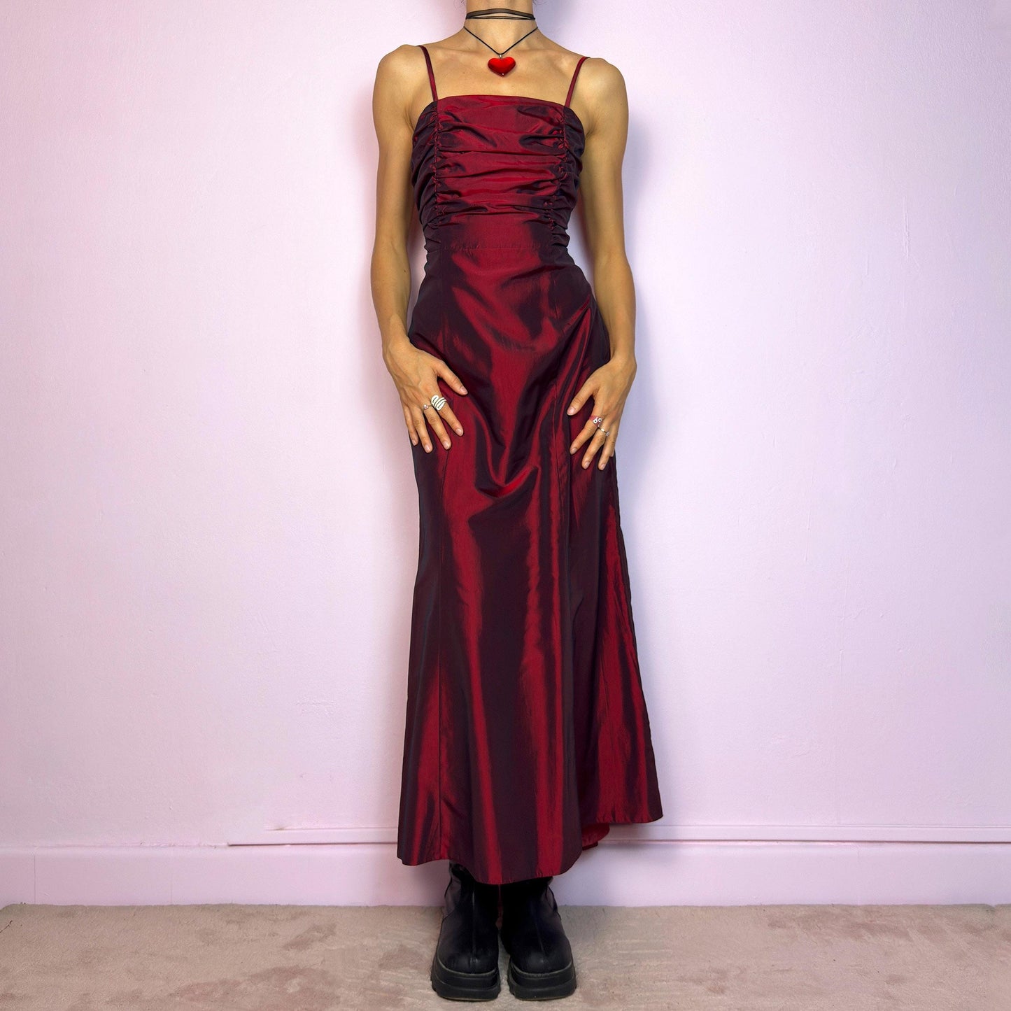 The Vintage 90s Burgundy Ruched Maxi Dress is a show-stopping piece featuring a rich burgundy tone with a lustrous satin-style finish. The ruched bodice adds texture and dimension, while the fitted silhouette flows into a soft A-line skirt. Designed with dainty spaghetti straps, a maxi length for dramatic flair, and a hidden side zipper closure for a seamless fit. Perfect for prom, formal events, or romantic night-outs. Excellent vintage condition.