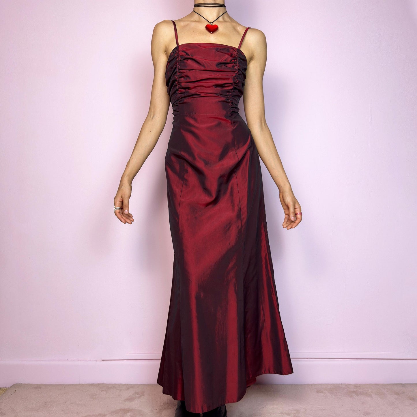 The Vintage 90s Burgundy Ruched Maxi Dress is a show-stopping piece featuring a rich burgundy tone with a lustrous satin-style finish. The ruched bodice adds texture and dimension, while the fitted silhouette flows into a soft A-line skirt. Designed with dainty spaghetti straps, a maxi length for dramatic flair, and a hidden side zipper closure for a seamless fit. Perfect for prom, formal events, or romantic night-outs. Excellent vintage condition.