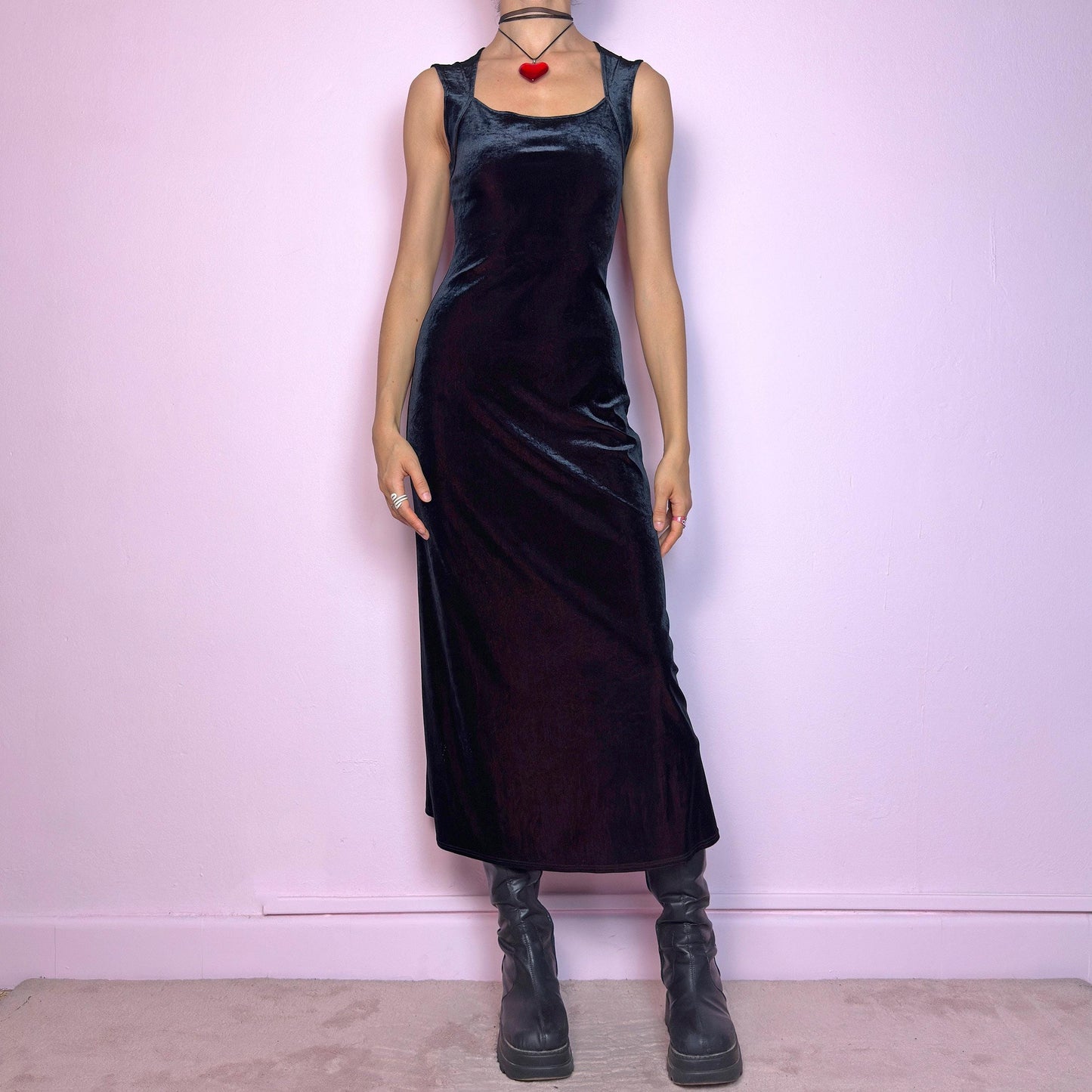 The Vintage 90s Black Velvet Midi Dress is pure elegance with a twist. Crafted from deep black velvet with a maroon undertone, it catches the light with rich, dark burgundy reflections that give it a luxe finish. Features wide straps, a square neckline, and a body-hugging midi silhouette that flatters and elongates. Soft and stretchy for comfort, yet bold and dramatic for gothic, romantic, or night-out looks. A subtly striking piece that stands out in movement and moonlight.