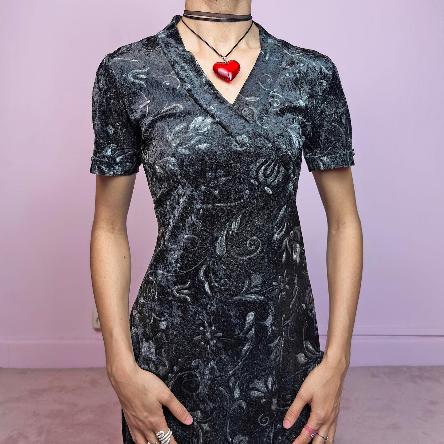The Vintage 90s Gray Velvet Midi Dress is a moody and elegant 90s piece made from soft, stretchy dark gray velvet with a baroque-style printed pattern. Features a flattering V-neckline, short sleeves, and a sleek longline silhouette. The velvety fabric gives it a luxurious feel while staying comfy. Perfect for witchy aesthetics, gothic romance, or vintage night-out looks.