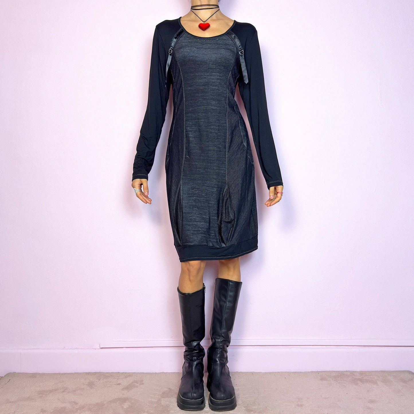 The Y2K Black Deconstructed Mini Dress is a rare cyber-inspired piece featuring a body-hugging silhouette with a subtle sheen. The dress combines soft jersey and panels with contrast stitching for a deconstructed effect. Long sleeves and a rounded neckline are accented by satin strap and D-ring details. Stretchy and sleek, it's perfect for dystopian minimalism, post-apocalyptic fashion, or edgy everyday wear. Made in France. Great vintage condition.