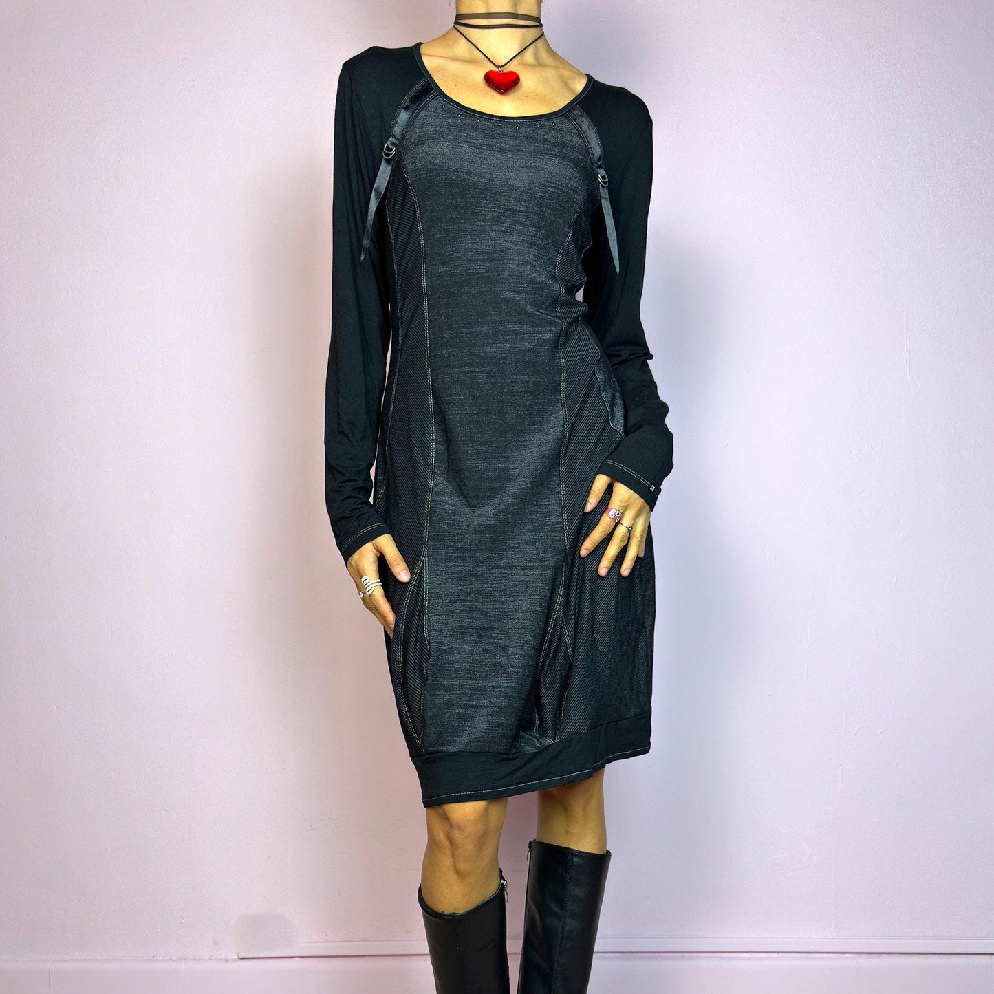 The Y2K Black Deconstructed Mini Dress is a rare cyber-inspired piece featuring a body-hugging silhouette with a subtle sheen. The dress combines soft jersey and panels with contrast stitching for a deconstructed effect. Long sleeves and a rounded neckline are accented by satin strap and D-ring details. Stretchy and sleek, it's perfect for dystopian minimalism, post-apocalyptic fashion, or edgy everyday wear. Made in France. Great vintage condition.
