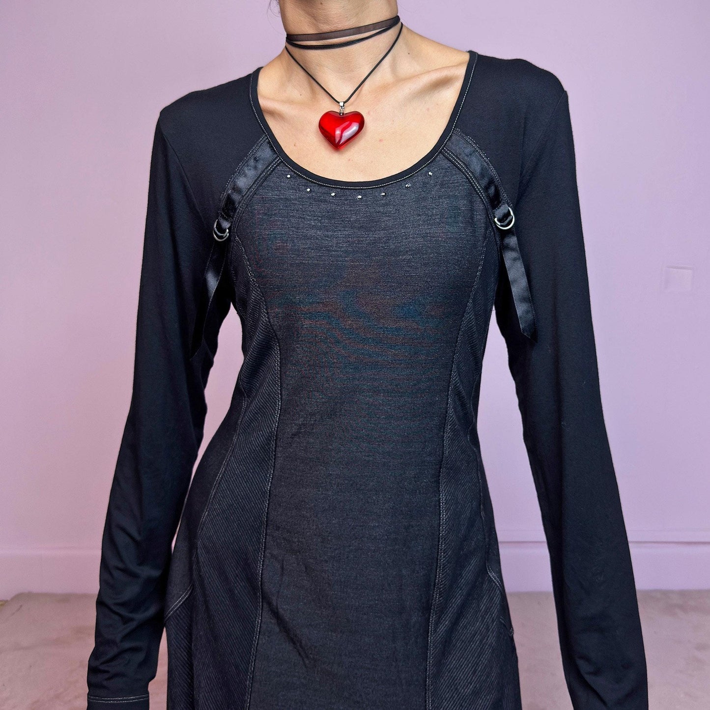 The Y2K Black Deconstructed Mini Dress is a rare cyber-inspired piece featuring a body-hugging silhouette with a subtle sheen. The dress combines soft jersey and panels with contrast stitching for a deconstructed effect. Long sleeves and a rounded neckline are accented by satin strap and D-ring details. Stretchy and sleek, it's perfect for dystopian minimalism, post-apocalyptic fashion, or edgy everyday wear. Made in France. Great vintage condition.