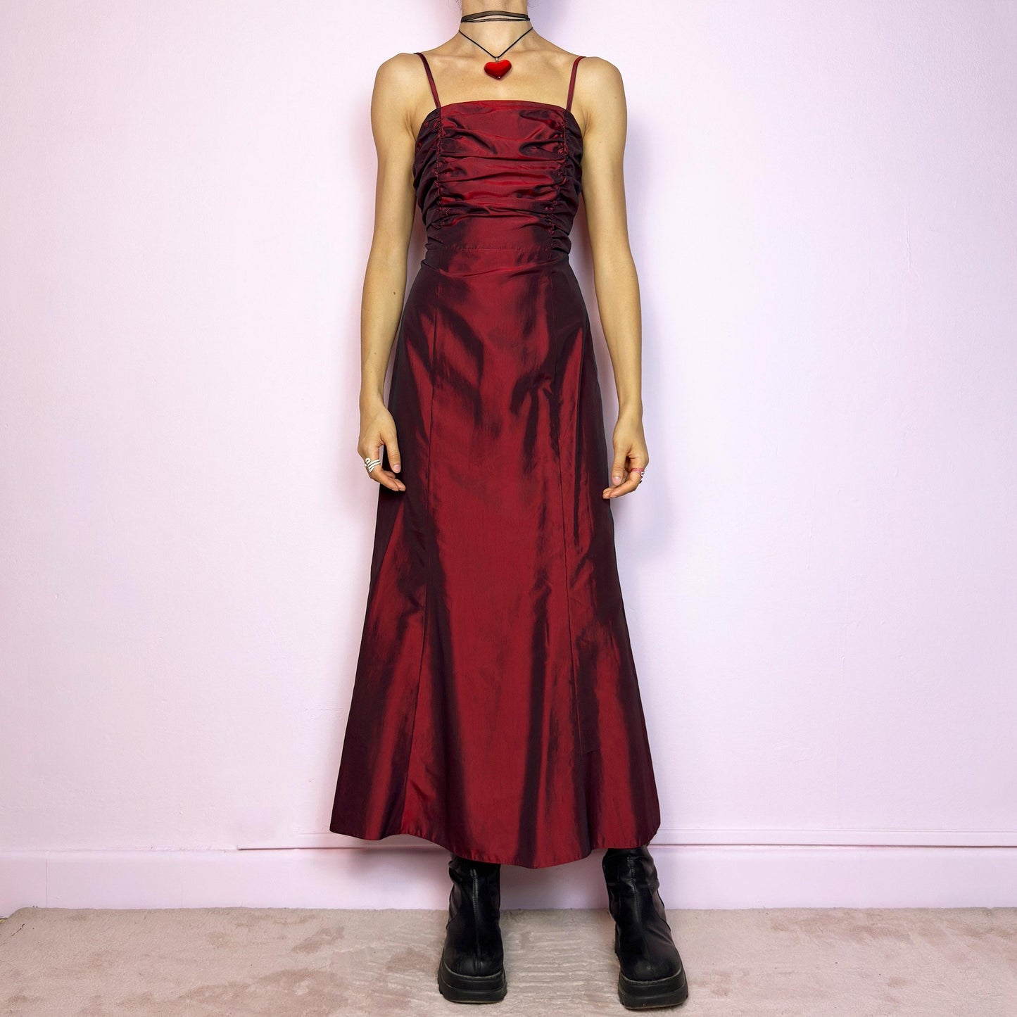 The Vintage 90s Burgundy Ruched Maxi Dress is a show-stopping piece featuring a rich burgundy tone with a lustrous satin-style finish. The ruched bodice adds texture and dimension, while the fitted silhouette flows into a soft A-line skirt. Designed with dainty spaghetti straps, a maxi length for dramatic flair, and a hidden side zipper closure for a seamless fit. Perfect for prom, formal events, or romantic night-outs. Excellent vintage condition.