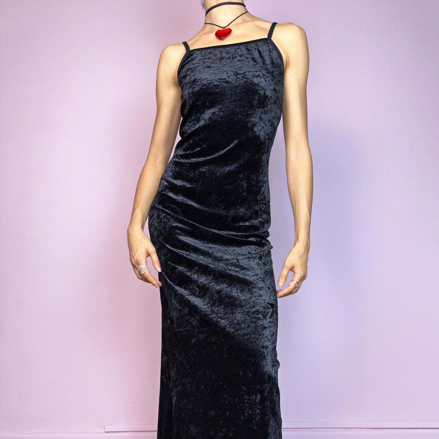 The Vintage 90s Black Velvet Slip Dress is a minimalist goth dream crafted from soft, stretchy black velvet with a subtle shine. This slip-style piece features a sleek scoop neckline, delicate spaghetti straps, and a flattering, body-hugging fit. The midi length adds a timeless silhouette that’s both romantic and effortlessly edgy. Perfect for layering or wearing solo, this dress is a go-to for witchy glam, grunge nights, or 90s-inspired minimal looks. Made in Europe. Great vintage condition.