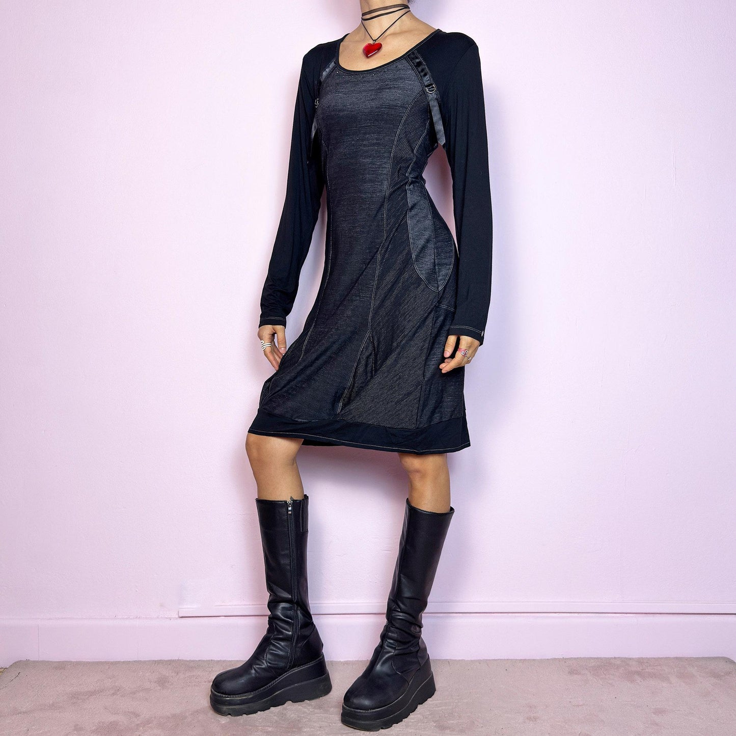 The Y2K Black Deconstructed Mini Dress is a rare cyber-inspired piece featuring a body-hugging silhouette with a subtle sheen. The dress combines soft jersey and panels with contrast stitching for a deconstructed effect. Long sleeves and a rounded neckline are accented by satin strap and D-ring details. Stretchy and sleek, it's perfect for dystopian minimalism, post-apocalyptic fashion, or edgy everyday wear. Made in France. Great vintage condition.