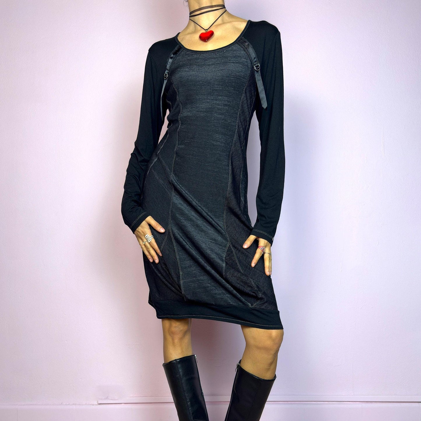 The Y2K Black Deconstructed Mini Dress is a rare cyber-inspired piece featuring a body-hugging silhouette with a subtle sheen. The dress combines soft jersey and panels with contrast stitching for a deconstructed effect. Long sleeves and a rounded neckline are accented by satin strap and D-ring details. Stretchy and sleek, it's perfect for dystopian minimalism, post-apocalyptic fashion, or edgy everyday wear. Made in France. Great vintage condition.