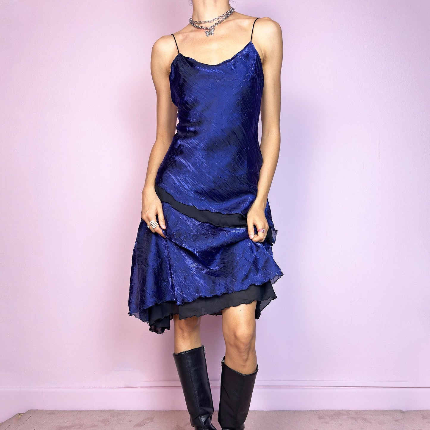 This vintage 90s midi dress features rich cobalt blue crinkled fabric over a black base with asymmetric layered panels. The fluid A-line silhouette and thin spaghetti straps create soft movement and luminous drape. Made from lightweight material with no stretch. A romantic and timeless piece for formal summer occasions—elegant, sculptural, and made to be remembered. Excellent vintage condition.