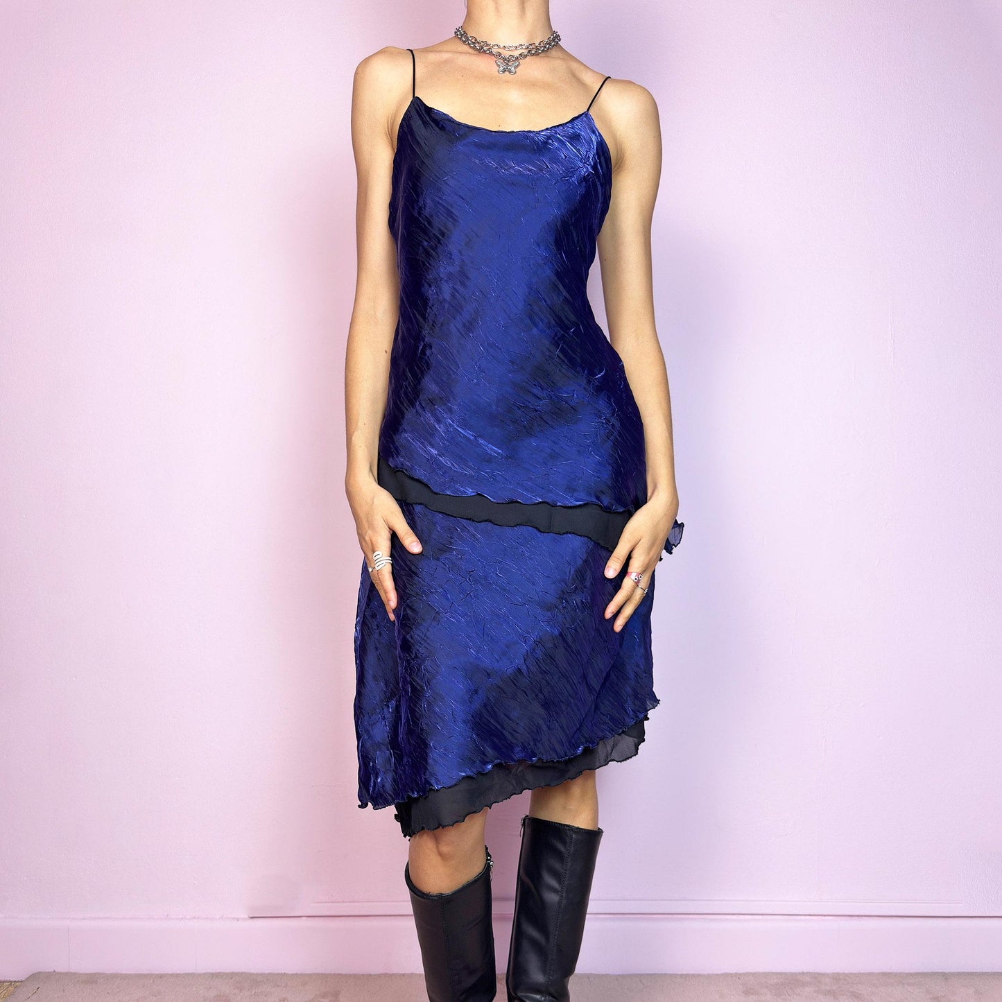 This vintage 90s midi dress features rich cobalt blue crinkled fabric over a black base with asymmetric layered panels. The fluid A-line silhouette and thin spaghetti straps create soft movement and luminous drape. Made from lightweight material with no stretch. A romantic and timeless piece for formal summer occasions—elegant, sculptural, and made to be remembered. Excellent vintage condition.
