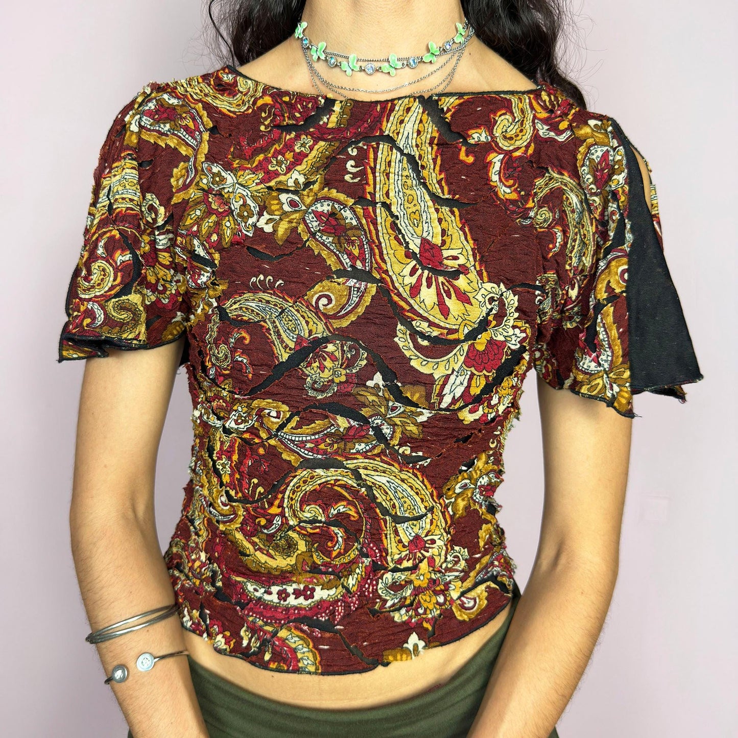 This vintage 2000s crinkle mesh top stuns with yellow-gold paisley prints on a rich maroon base and a dramatic split short sleeve. Ideal for summer nights, art parties, or elegant outdoor dinner looks. A rare, textile-rich piece with gypsy-bohemian undertones and free-spirited dancing energy. Made of stretch polyester blend. Great vintage condition.