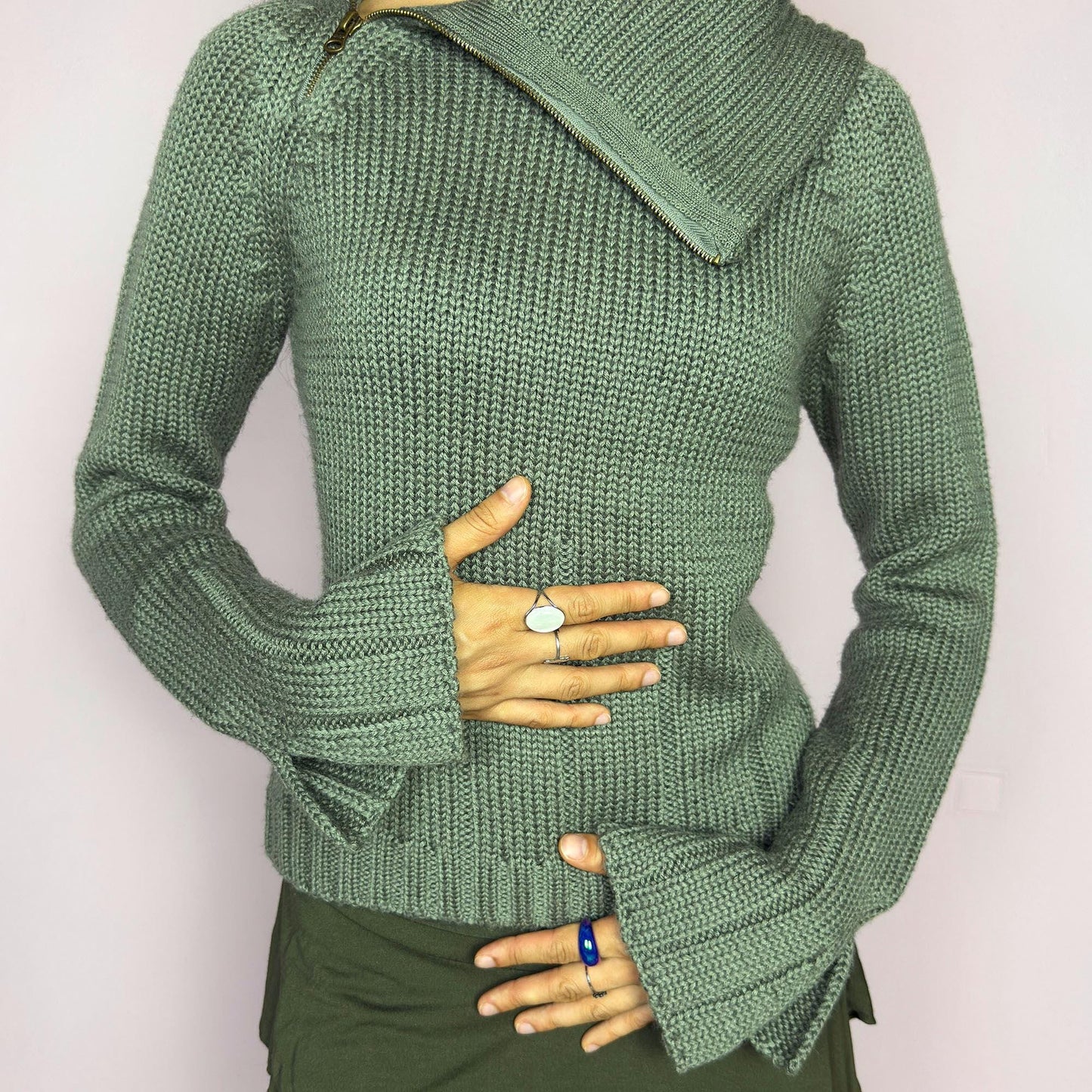 This vintage 2000s green knit sweater features a dramatic asymmetrical collar with exposed zipper and flared split cuffs. Ideal for deconstructed layering on autumn days, it radiates fairy grunge energy with a streetwear edge. A fluffy Y2K piece made of acrylic and wool for cozy warmth. Great vintage condition.