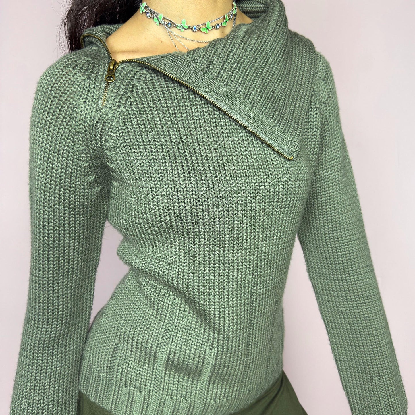 This vintage 2000s green knit sweater features a dramatic asymmetrical collar with exposed zipper and flared split cuffs. Ideal for deconstructed layering on autumn days, it radiates fairy grunge energy with a streetwear edge. A fluffy Y2K piece made of acrylic and wool for cozy warmth. Great vintage condition.