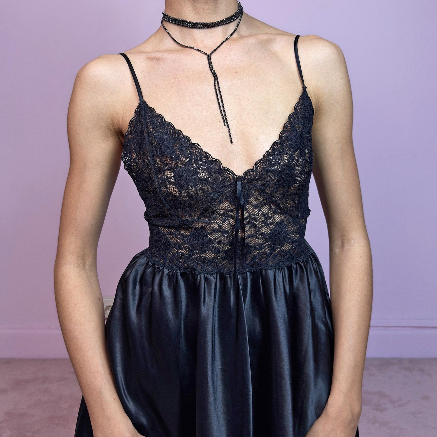 The vintage 90s black babydoll slip dress is soft seduction in lace and satin-style polyester. Features a fitted lace bodice with a plunging V-neckline, spaghetti straps, and a gathered satin skirt that falls mid-thigh. Lightweight with a subtle sheen, this piece moves effortlessly between lingerie-inspired romance and party-ready drama. A timeless classic for evening looks, summer nights, or dark feminine wardrobes. Made in Spain. Great vintage condition.