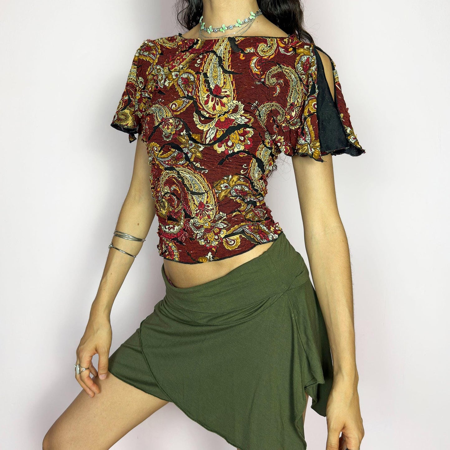This vintage 2000s crinkle mesh top stuns with yellow-gold paisley prints on a rich maroon base and a dramatic split short sleeve. Ideal for summer nights, art parties, or elegant outdoor dinner looks. A rare, textile-rich piece with gypsy-bohemian undertones and free-spirited dancing energy. Made of stretch polyester blend. Great vintage condition.
