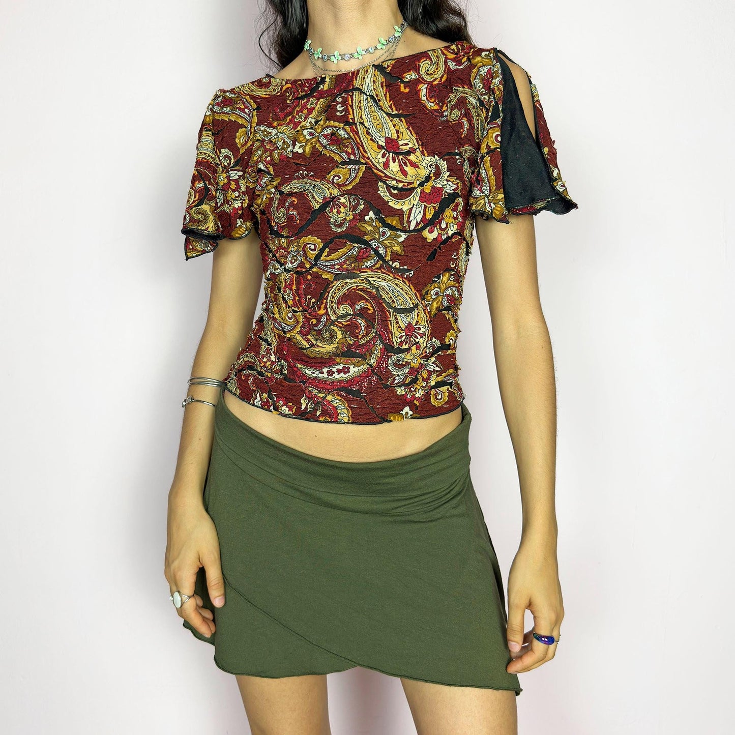 This vintage 2000s crinkle mesh top stuns with yellow-gold paisley prints on a rich maroon base and a dramatic split short sleeve. Ideal for summer nights, art parties, or elegant outdoor dinner looks. A rare, textile-rich piece with gypsy-bohemian undertones and free-spirited dancing energy. Made of stretch polyester blend. Great vintage condition.