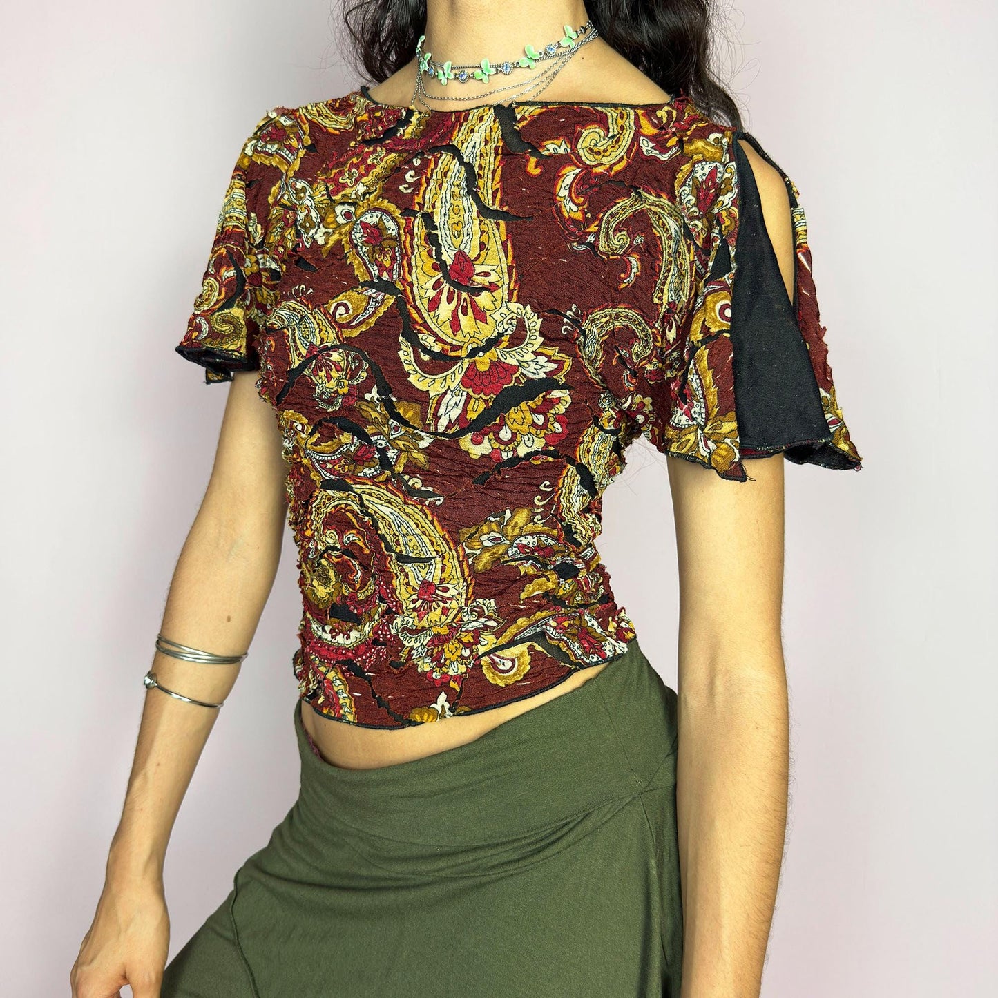 This vintage 2000s crinkle mesh top stuns with yellow-gold paisley prints on a rich maroon base and a dramatic split short sleeve. Ideal for summer nights, art parties, or elegant outdoor dinner looks. A rare, textile-rich piece with gypsy-bohemian undertones and free-spirited dancing energy. Made of stretch polyester blend. Great vintage condition.