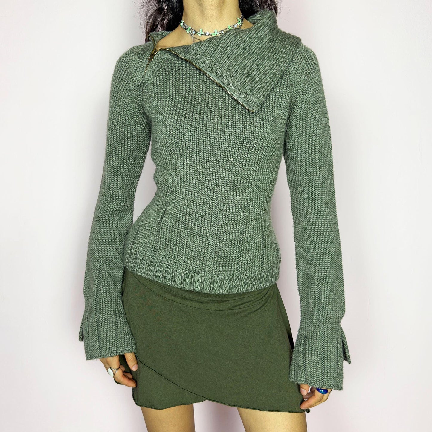 This vintage 2000s green knit sweater features a dramatic asymmetrical collar with exposed zipper and flared split cuffs. Ideal for deconstructed layering on autumn days, it radiates fairy grunge energy with a streetwear edge. A fluffy Y2K piece made of acrylic and wool for cozy warmth. Great vintage condition.