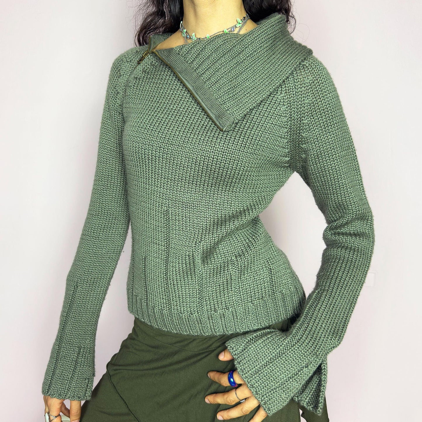 This vintage 2000s green knit sweater features a dramatic asymmetrical collar with exposed zipper and flared split cuffs. Ideal for deconstructed layering on autumn days, it radiates fairy grunge energy with a streetwear edge. A fluffy Y2K piece made of acrylic and wool for cozy warmth. Great vintage condition.