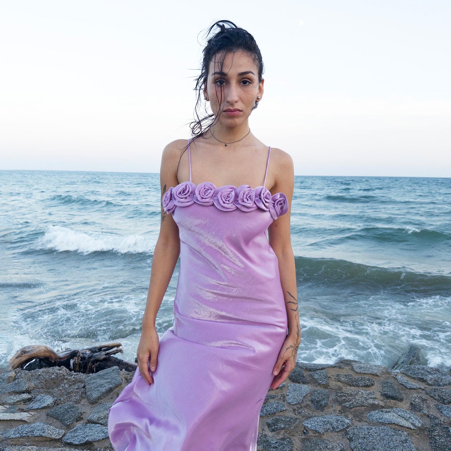 The vintage 2000s pastel lilac slip dress is a French-made fantasy with sculptural rosette appliqué along the bust. Its iridescent finish and fluid midi length evoke dreamy softness, perfect for proms, summer weddings, or romantic evenings. The silhouette captures fairytale allure with quiet glamour. A romantic Y2K archive crafted from a shimmering non-stretch polyester blend fabric. Excellent vintage condition.