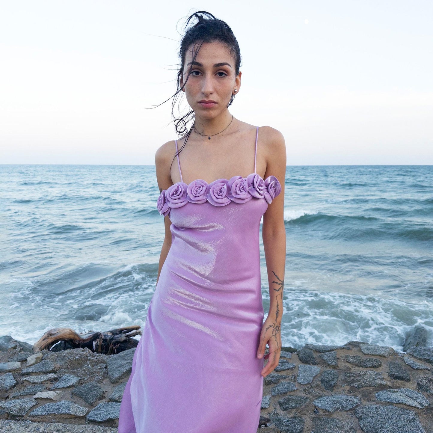 The vintage 2000s pastel lilac slip dress is a French-made fantasy with sculptural rosette appliqué along the bust. Its iridescent finish and fluid midi length evoke dreamy softness, perfect for proms, summer weddings, or romantic evenings. The silhouette captures fairytale allure with quiet glamour. A romantic Y2K archive crafted from a shimmering non-stretch polyester blend fabric. Excellent vintage condition.