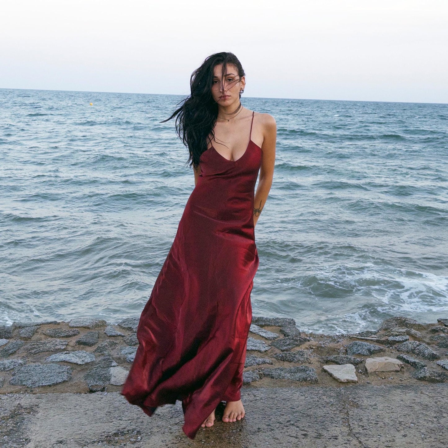 The vintage 2000s maroon slip dress is a French-made piece with high-shine finish, fluid silhouette, and delicate spaghetti straps. Its glossy depth and body-skimming cut evoke diva glamour and red carpet allure. Ideal for summer nights, cocktails, or sensual evening entrances. A romantic burgundy Y2K archive gown made from a non-stretch polyester blend fabric. Excellent vintage condition.