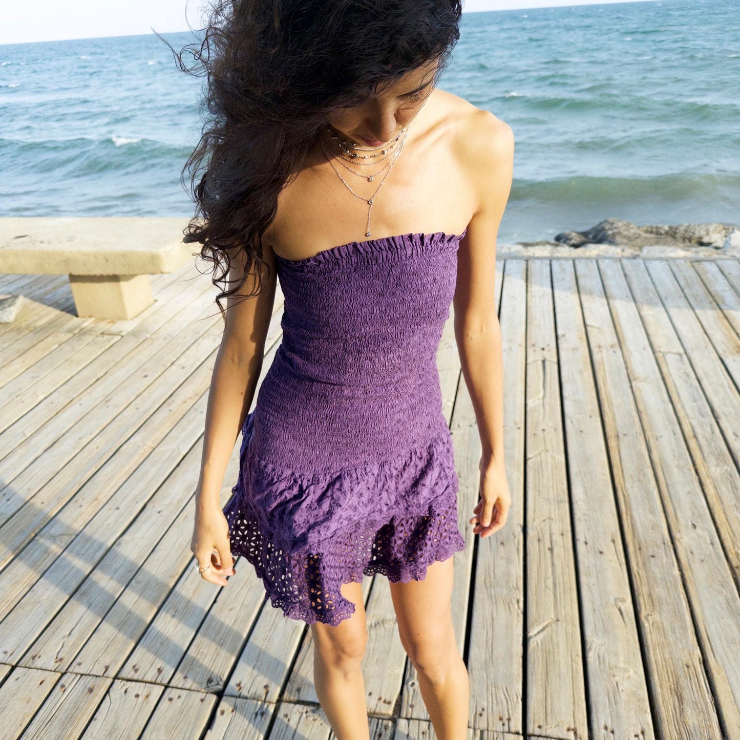 The vintage 90s purple strapless mini dress is a sunlit dream in ruched cotton with tiered ruffle lace hems. Made in Italy, its smocked bodice hugs the figure while the eyelet and broderie anglaise layers add texture and movement. Lightweight and easy, it channels boho fairy energy—perfect for holidays, summer parties, or barefoot cocktail hours. A romantic resort piece with sun-drenched charm. Great vintage condition.