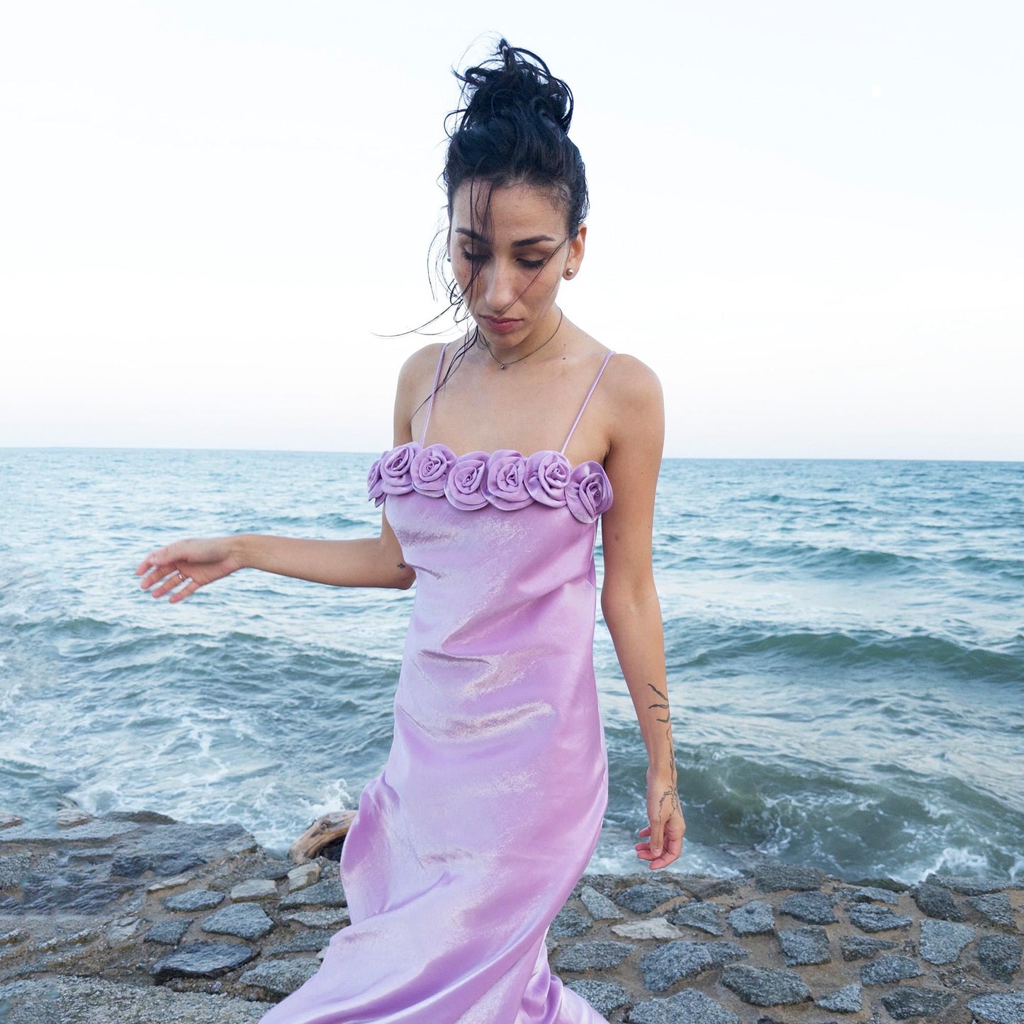 The vintage 2000s pastel lilac slip dress is a French-made fantasy with sculptural rosette appliqué along the bust. Its iridescent finish and fluid midi length evoke dreamy softness, perfect for proms, summer weddings, or romantic evenings. The silhouette captures fairytale allure with quiet glamour. A romantic Y2K archive crafted from a shimmering non-stretch polyester blend fabric. Excellent vintage condition.