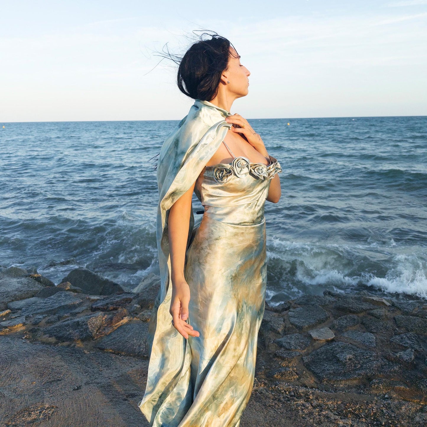 The vintage 2000s pastel tie-dye slip dress is a French-made fantasy in soft blues, greens, and gold. With sculptural rosette appliqué along the bust and a matching scarf, it moves like light on water. The shiny satin-style finish and fluid midi length evoke fairytale softness—ideal for proms, weddings, or summer nights. A romantic Y2K archive crafted from a shimmering non-stretch polyester blend. Great vintage condition.