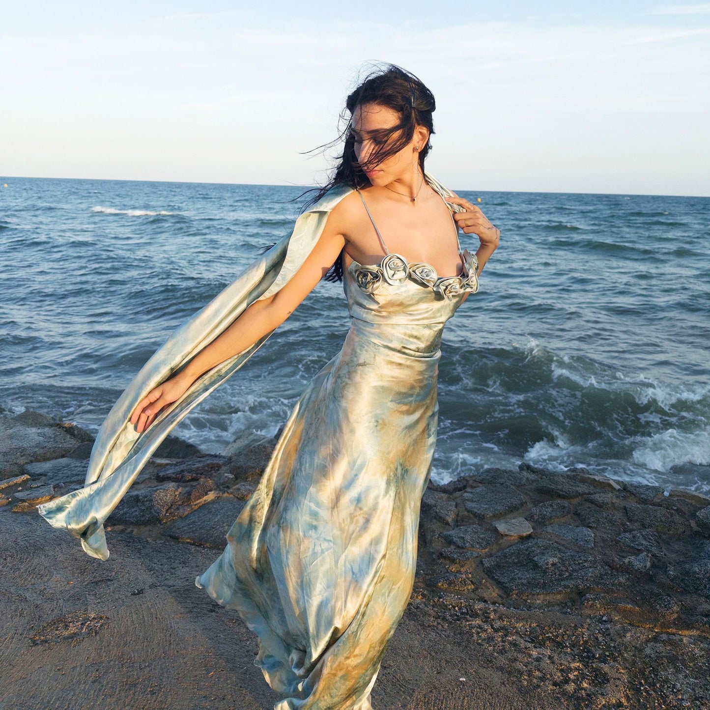 The vintage 2000s pastel tie-dye slip dress is a French-made fantasy in soft blues, greens, and gold. With sculptural rosette appliqué along the bust and a matching scarf, it moves like light on water. The shiny satin-style finish and fluid midi length evoke fairytale softness—ideal for proms, weddings, or summer nights. A romantic Y2K archive crafted from a shimmering non-stretch polyester blend. Great vintage condition.