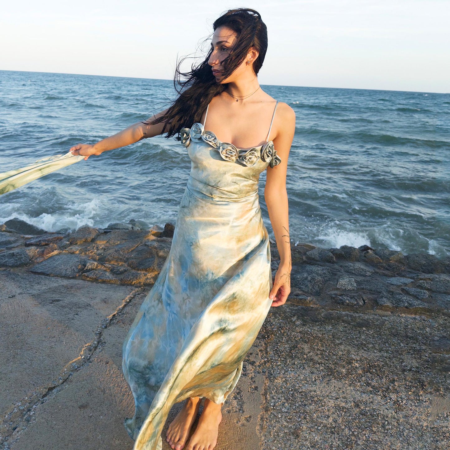 The vintage 2000s pastel tie-dye slip dress is a French-made fantasy in soft blues, greens, and gold. With sculptural rosette appliqué along the bust and a matching scarf, it moves like light on water. The shiny satin-style finish and fluid midi length evoke fairytale softness—ideal for proms, weddings, or summer nights. A romantic Y2K archive crafted from a shimmering non-stretch polyester blend. Great vintage condition.